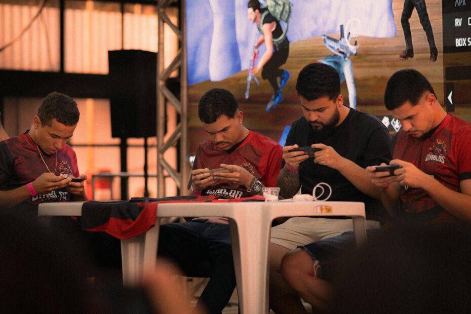 Group of gamers intensely focused during a mobile e-sports tournament indoors.
