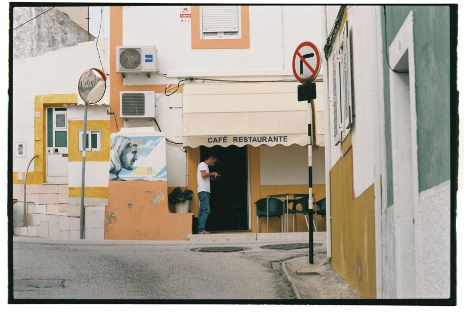 A picturesque street in Lisbon featuring a quaint café and urban details.