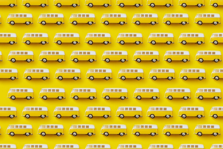 A vibrant design featuring a repeating pattern of yellow and white retro vans on a bright yellow background.