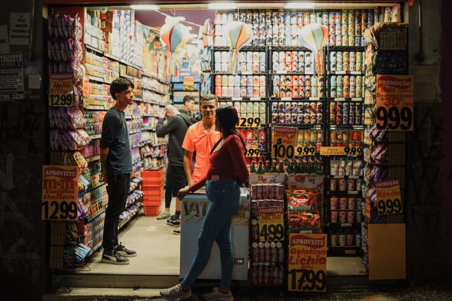 Vibrant night scene of a street market in São Paulo, Brazil, showcasing colorful displays and lively atmosphere.