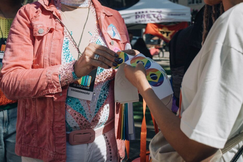 People engaging at an outdoor community event promoting LGBT pride and inclusion.