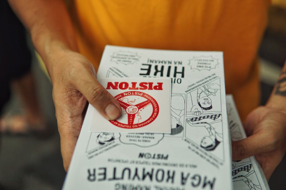 A close-up shot of hands distributing flyers with activism and protest themes.