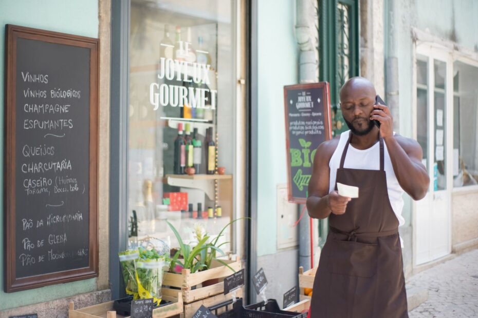 A grocery store vendor making a phone call at a gourmet shop in Lisbon, Portugal.