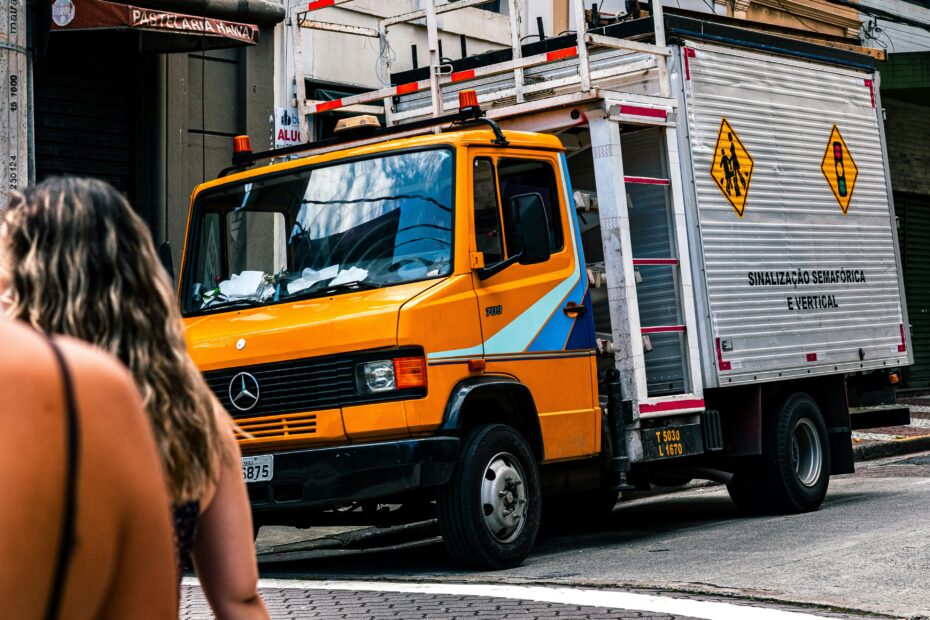 Orange delivery truck parked on a city street